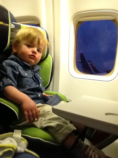 First big boy flight with his own seat. On the way back we were told we couldn't use this seat because it wasn't airline compliant. Gotta love consistency.